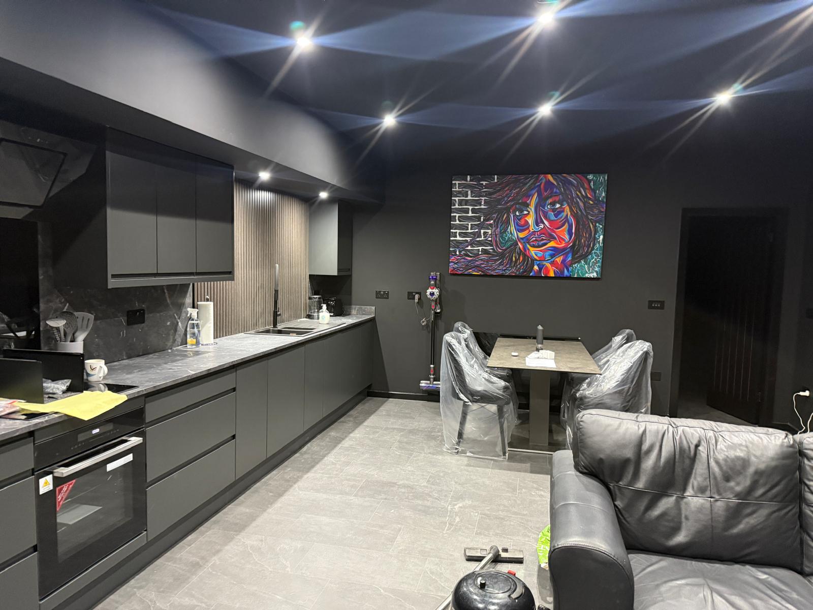 Open-plan kitchen and living area with dining table and seating