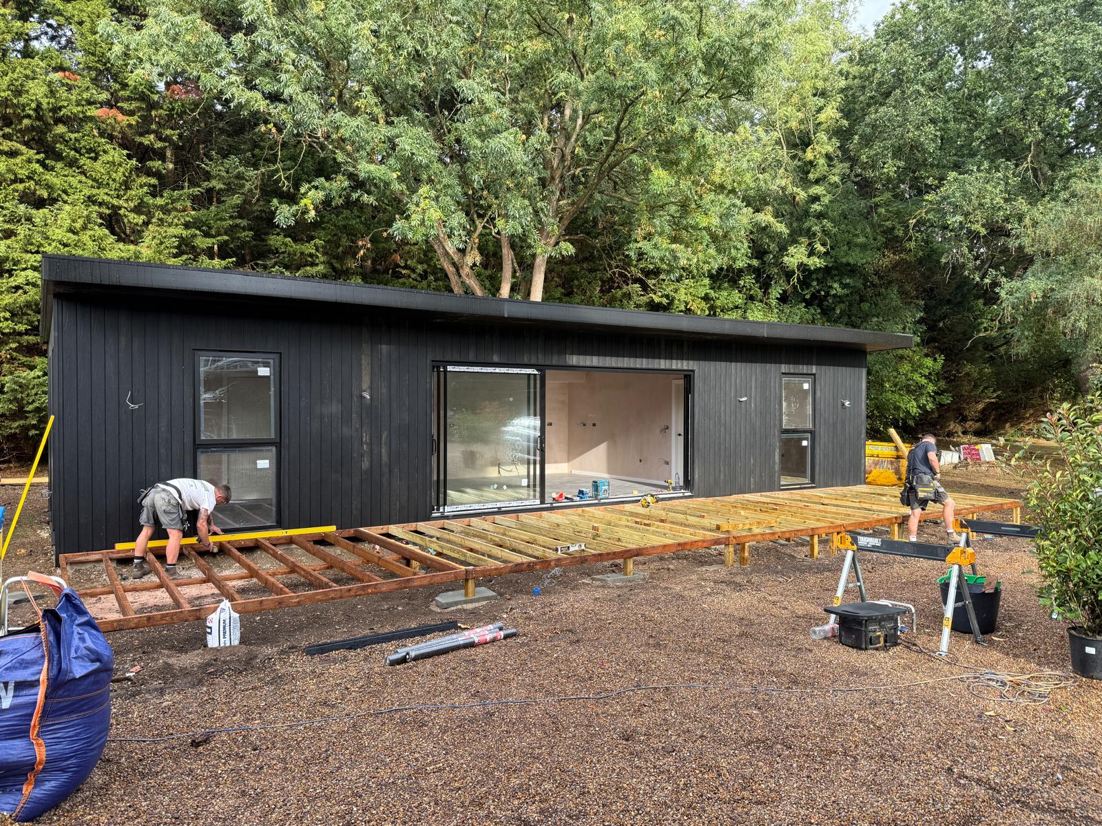 Wide view of the annexe with the timber decking frame under construction