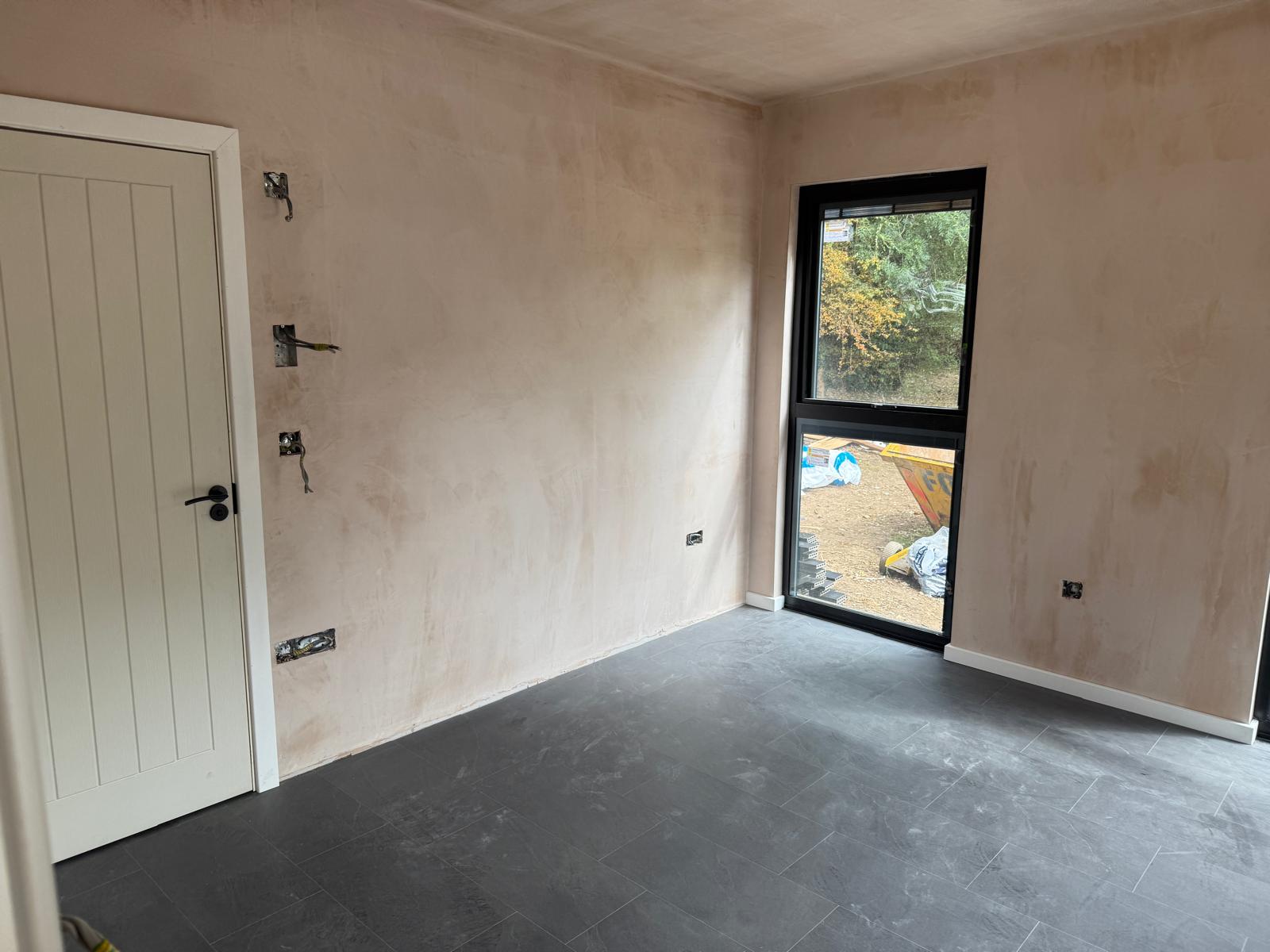 Second bedroom with full height window and slate tiled floor