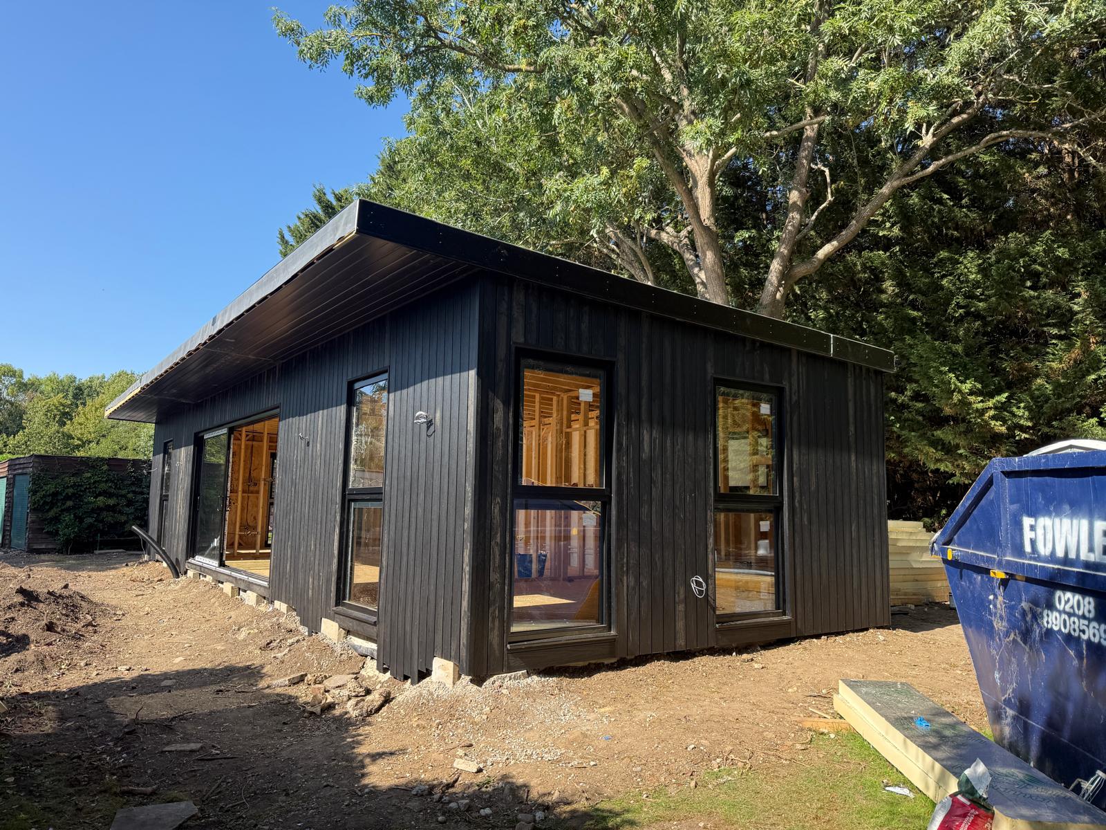 Black clad annexe with windows fitted and glazing in place
