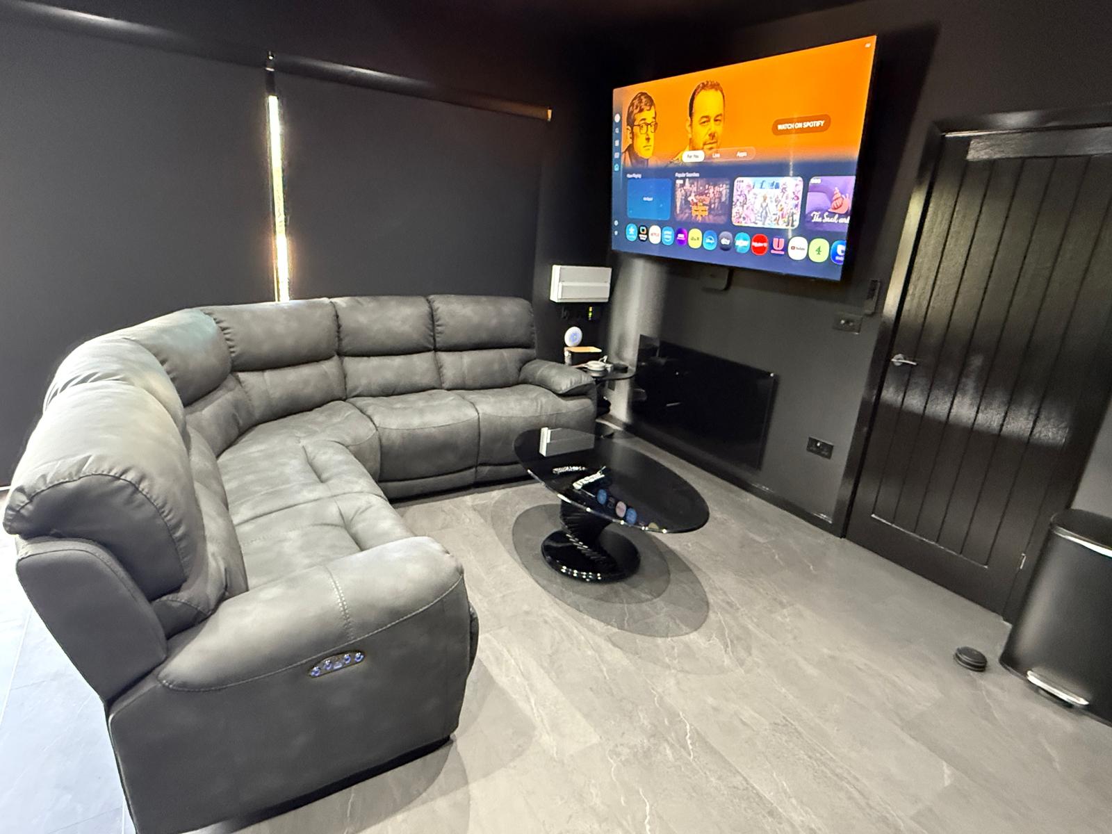 Living area with corner sofa and wall mounted television